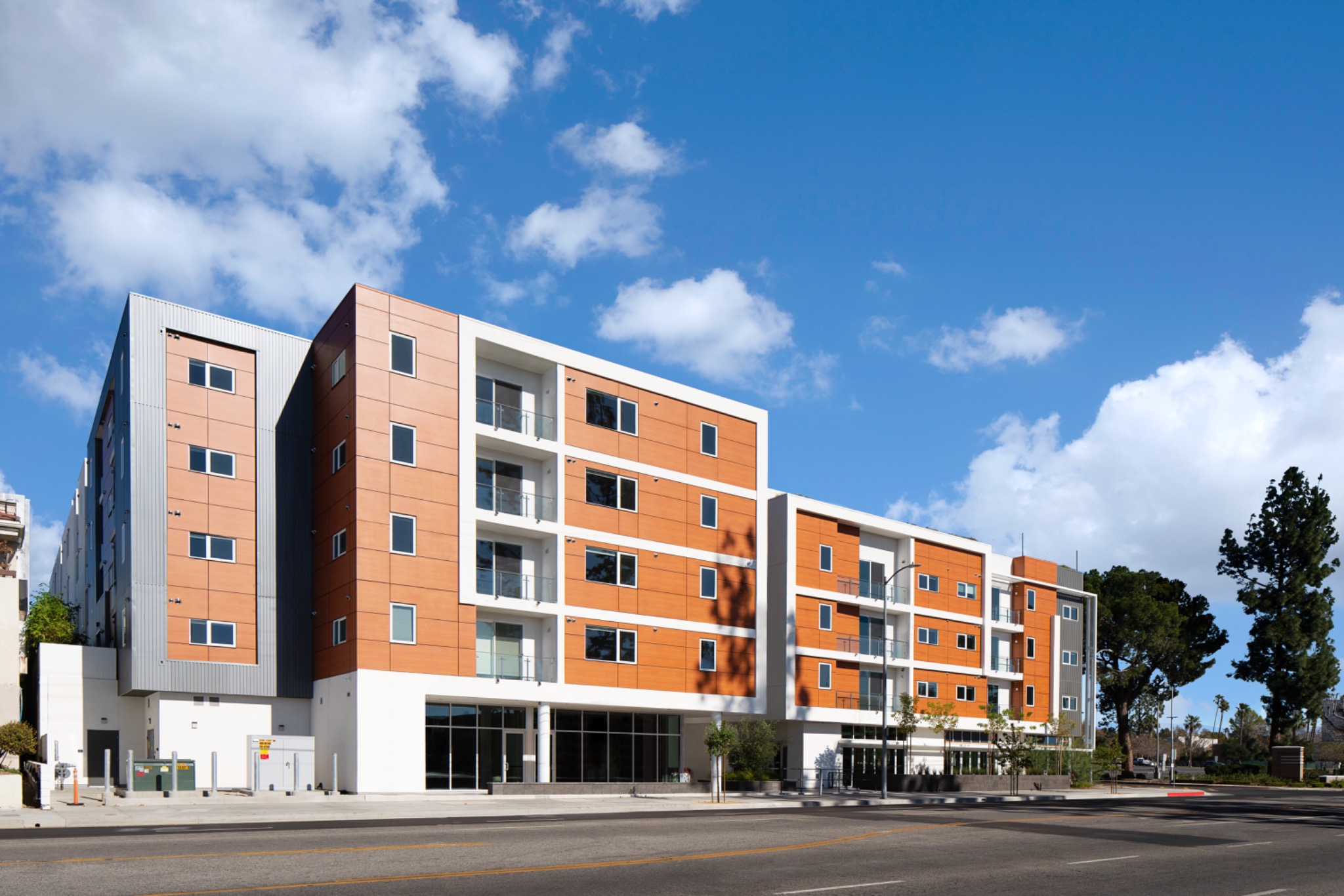 Aspire Northridge apartment building with orange and white exterior panels on Darby Avenue